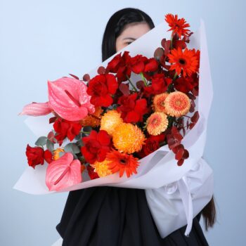 Vibrant Bouquet with Deco Painted, Explorer, Mini Gerbera, and Anthurium flowers accented by painted Eucalyptus.