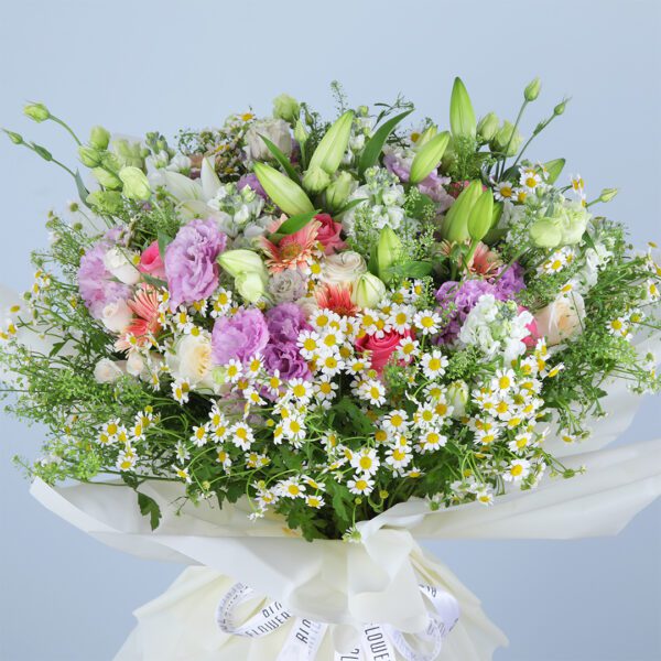 A vibrant pink bouquet with 10 pink gerberas, 10 pink roses, 10 white ohara lilies, 10 tanacetrum, 10 bublurium, 10 white lilies, 10 mathiola, 1 bunch purple lisianthus, and 10 white baby roses.