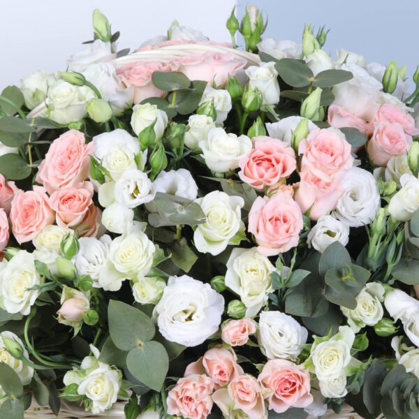 Beautiful floral basket of soft pink Sweet Sara roses, white spray roses, and eucalyptus for a fresh look.