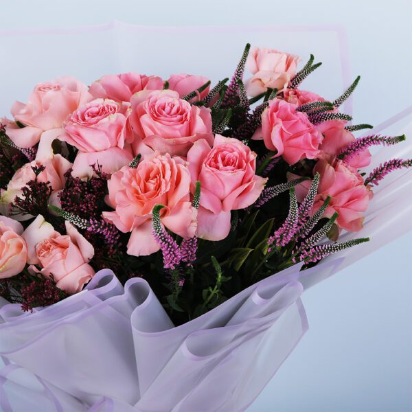 Elegant bouquet with peach harmony roses, veronica stems, and vibrant African flowers.