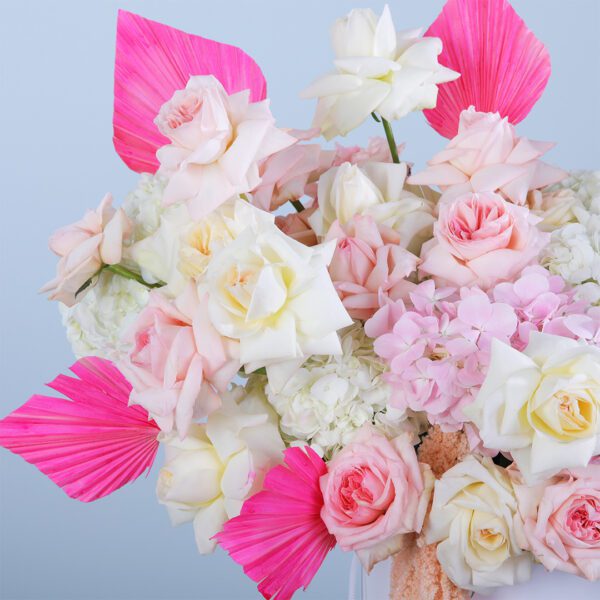 A stunning flower box filled with white hydrangeas, pink Ohara roses, and stylish dry leaves, exuding sophistication and charm.