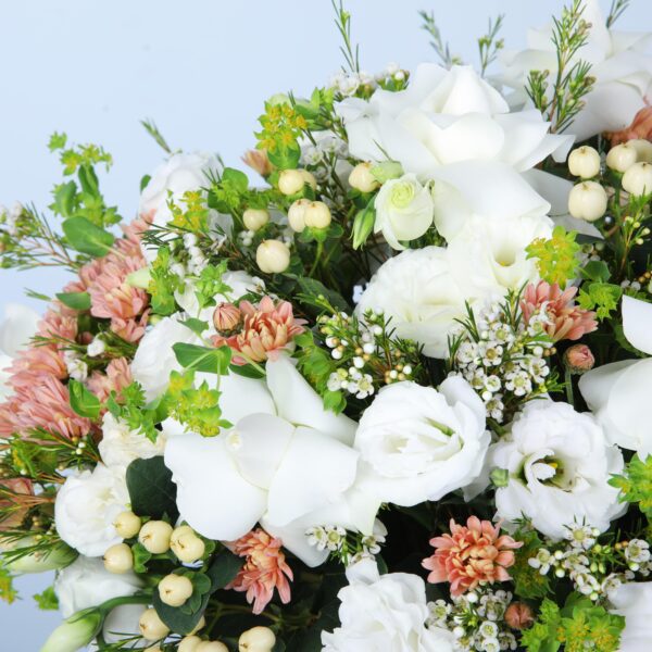 A beautifully curated basket of white flowers highlighting the elegance and the charm of floral beauty.