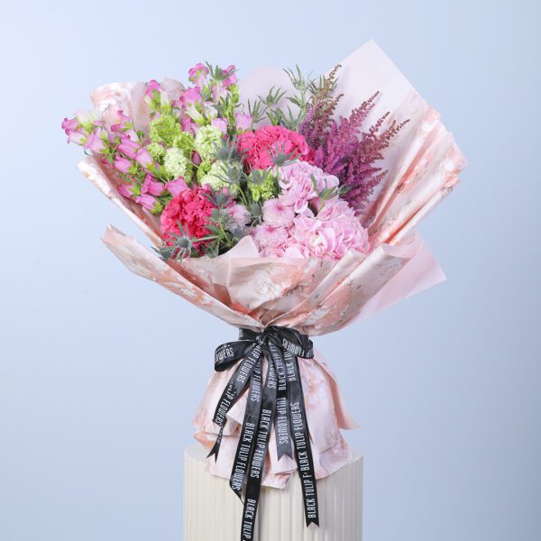 Vibrant mixed flower bouquet featuring a variety of seasonal blooms in bright colors.