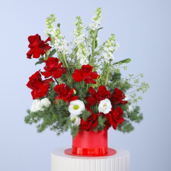 Beautiful floral hat box containing 10 red roses, 10 Mathiolla, and 5 white lisianthus with lush greens.