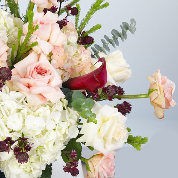 Black Hat Box Filled with Peach Roses and White Hydrangeas