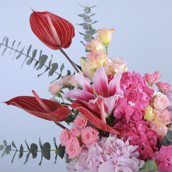 Vibrant Bouquet Featuring Pink Hydrangeas, Red Anthurium, Roses, Lilies, and Greenery in a Vase