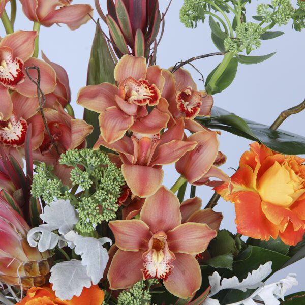 Mixed vibrant blooms in a vase create a charming and lively centerpiece.